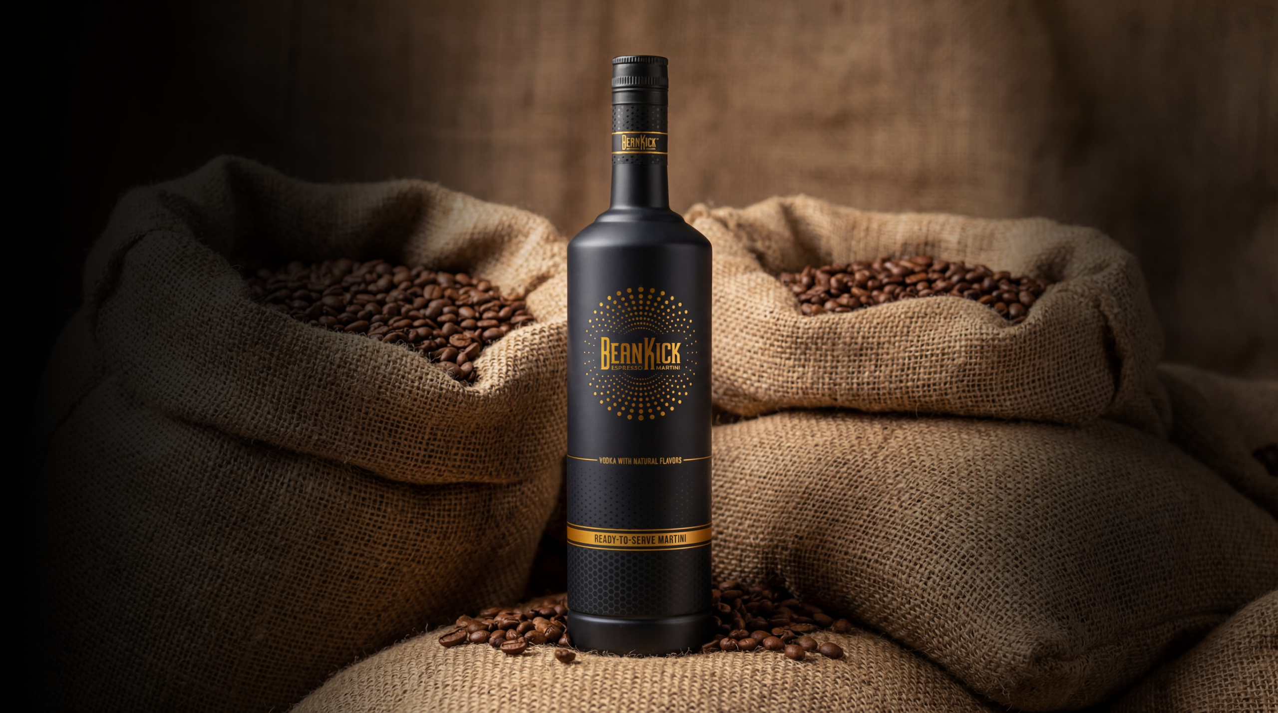BeanKick bottle resting on roasted coffee beans